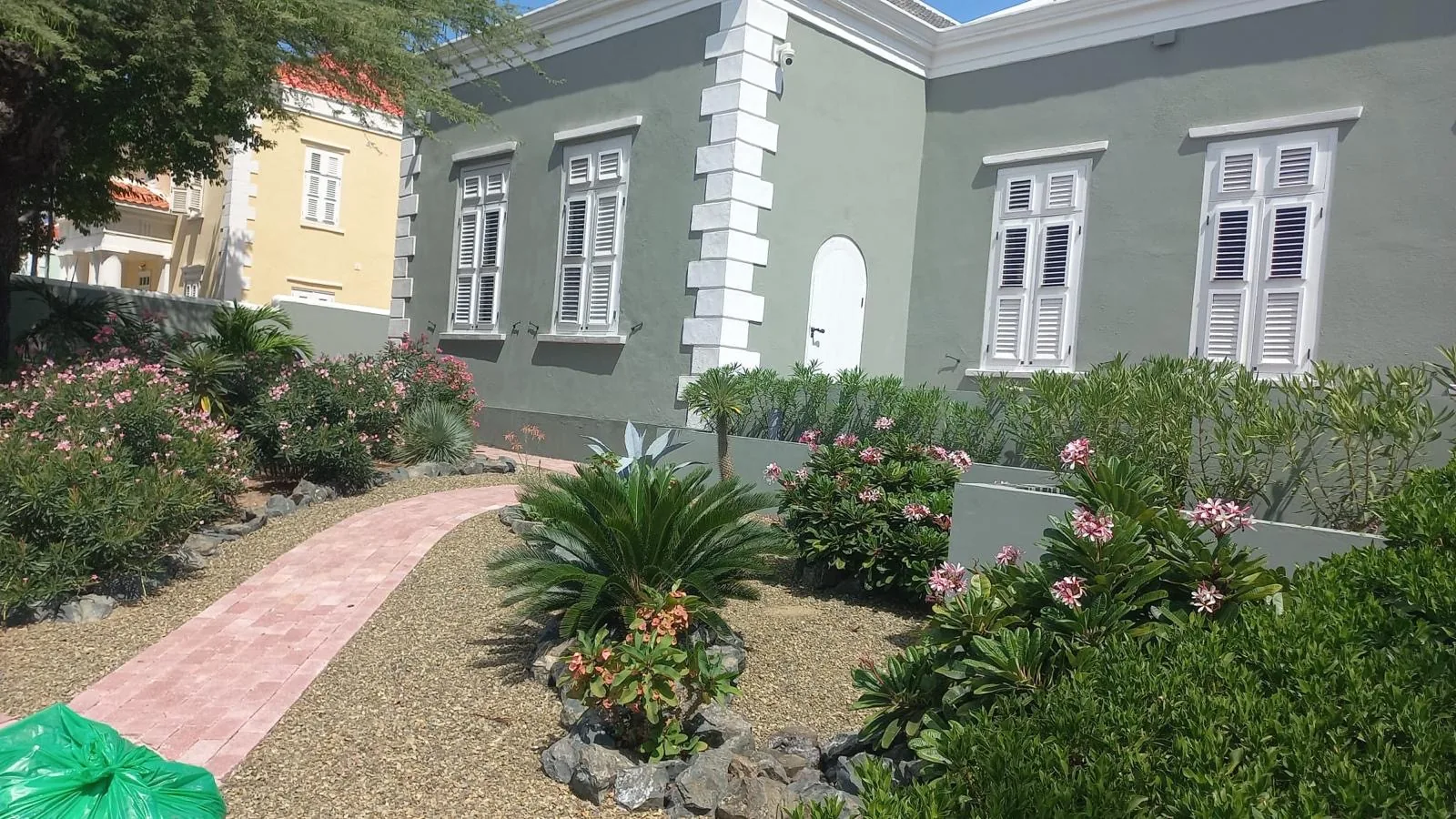 Voortuin met klinkerpad, cycas en frangipani